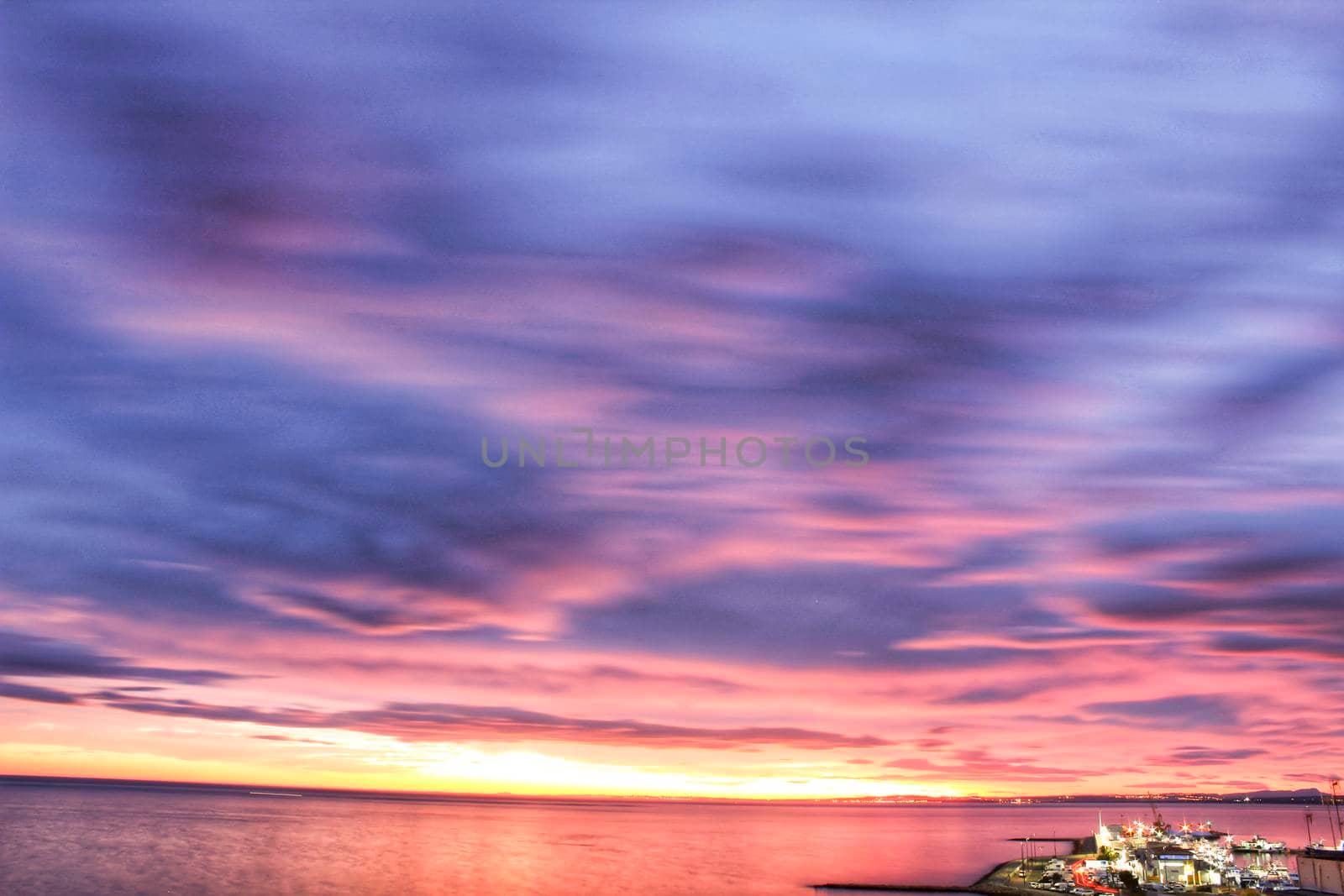 Spectacular and colorful sunset in the bay of Santa Pola, Alicante, Spain in autumn