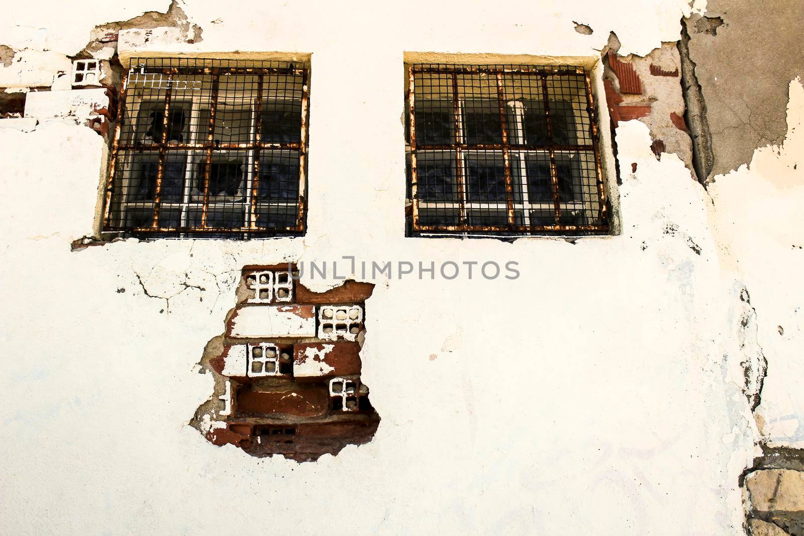 Old and damaged wall texture with windows