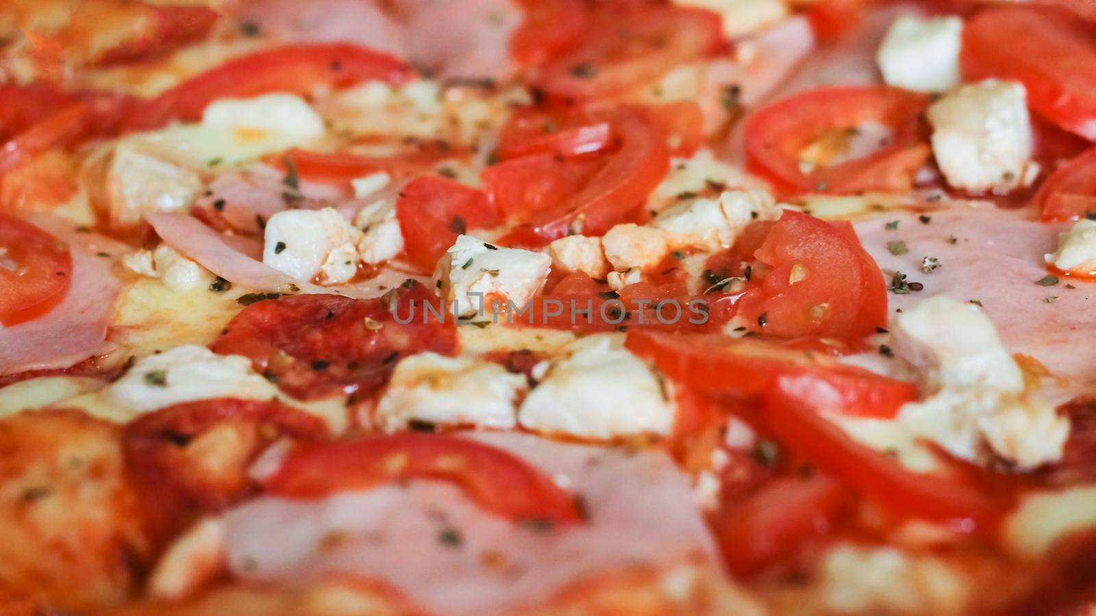 Pizza with chicken, cheese and ham close up, background or texture