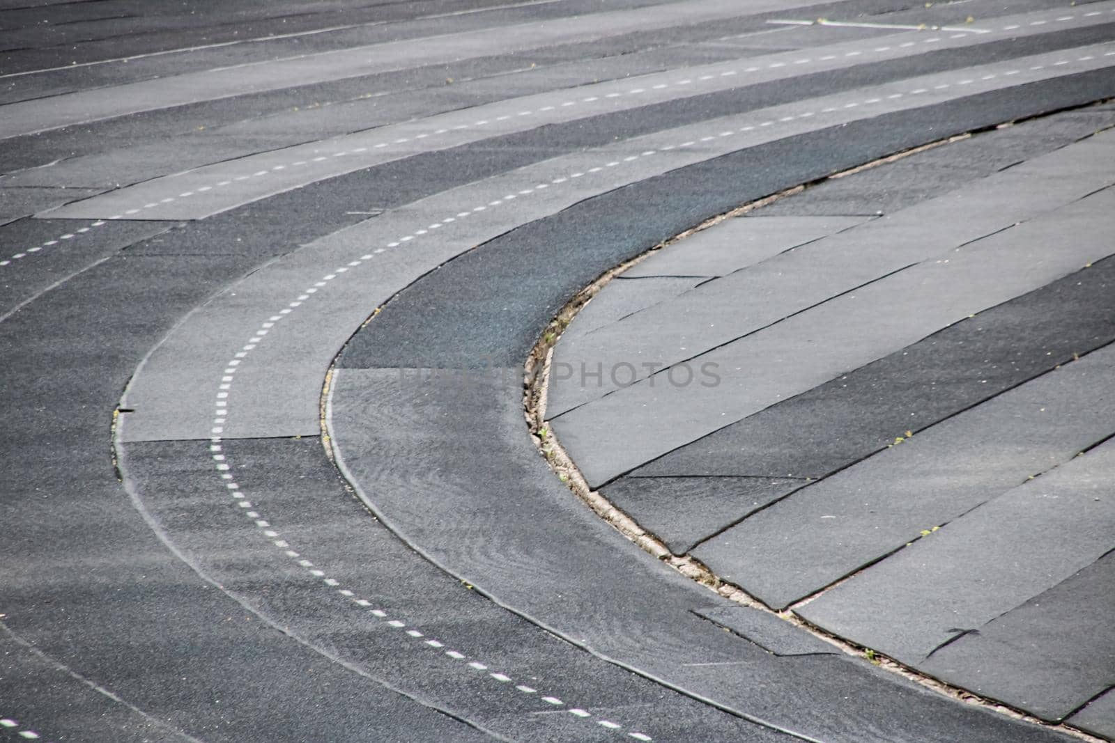 Gray running track in the stadium close up, background