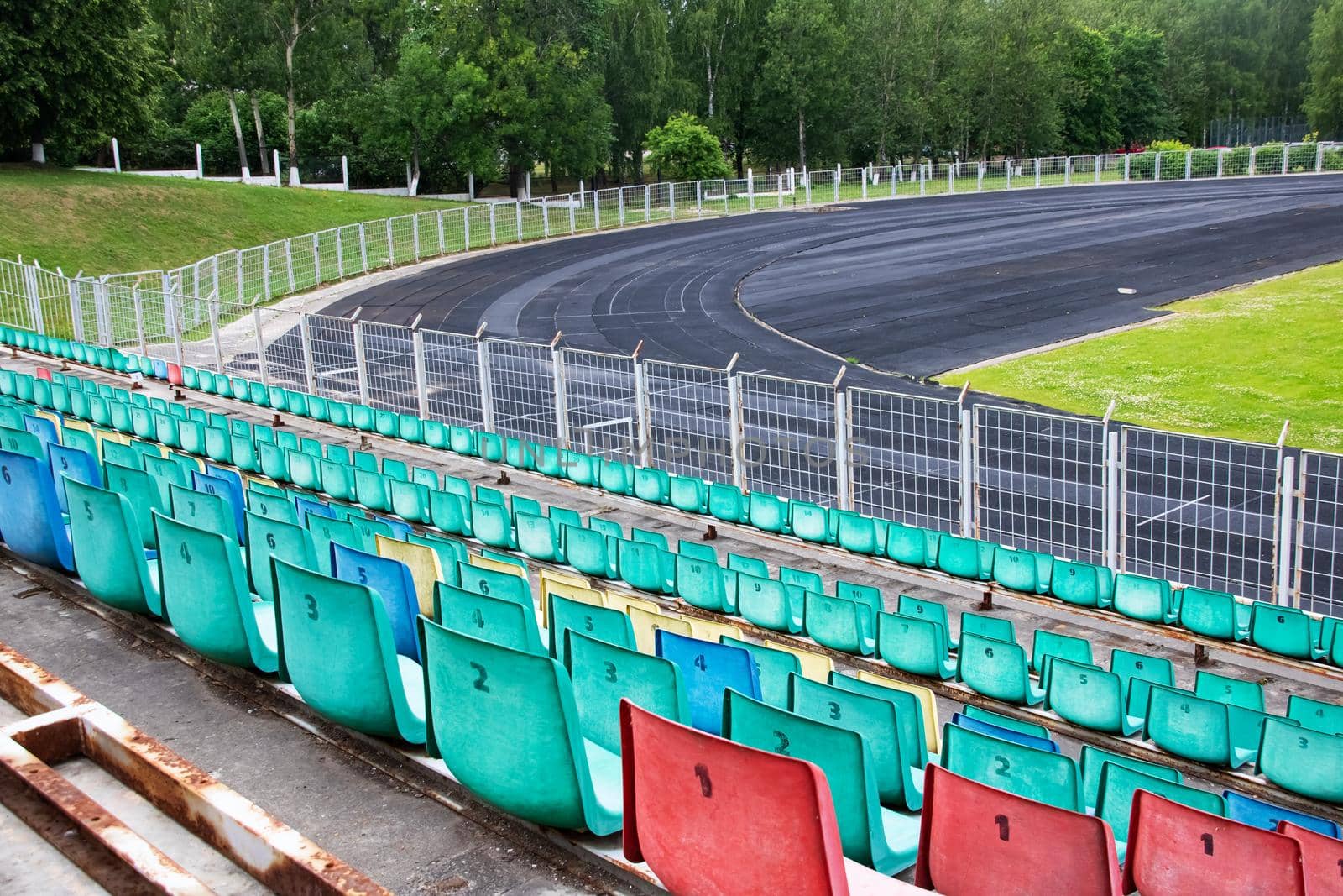 Seats and running track in the stadium in summer