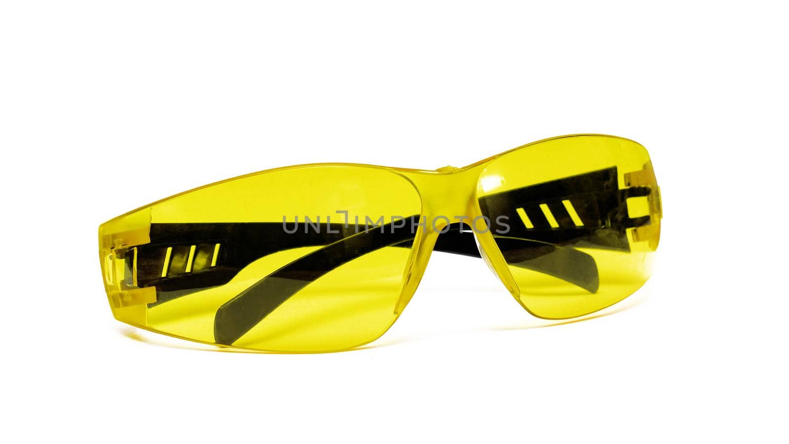 Yellow safety glasses close up, isolated on a white background