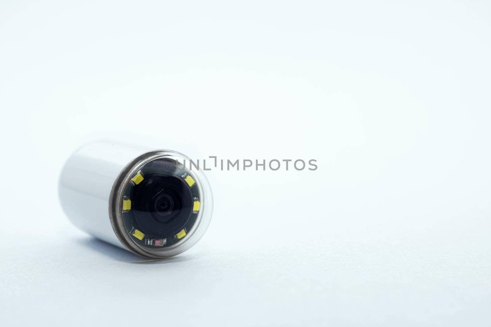 Capsule with camera for capsular endoscopy close up on white background, copy space