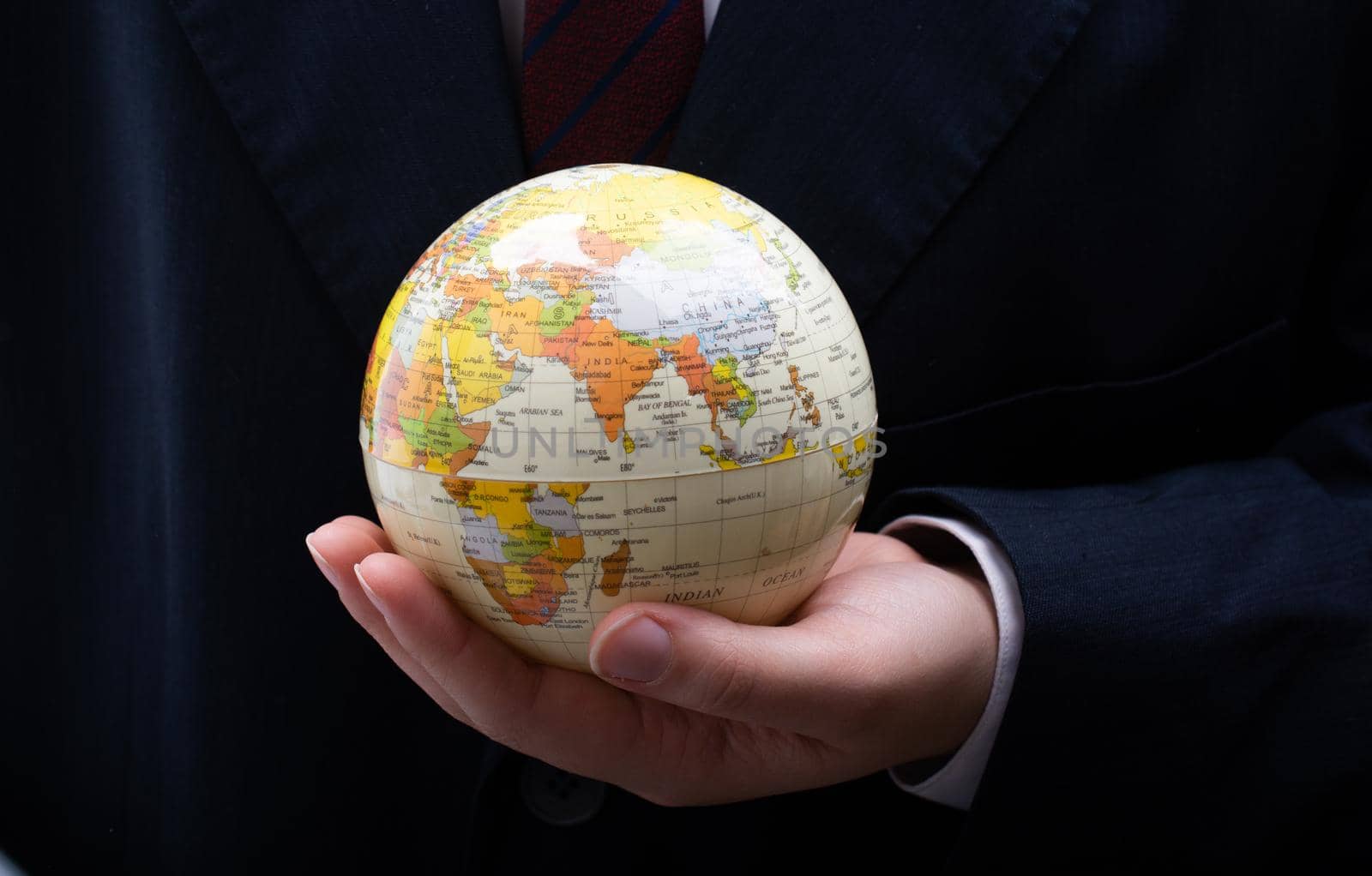 Businessman is standing with an earth globe fot business concept