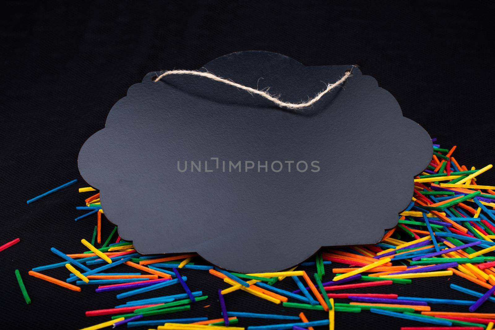 Black speech bubble shaped notice board  on colorful sticks on black