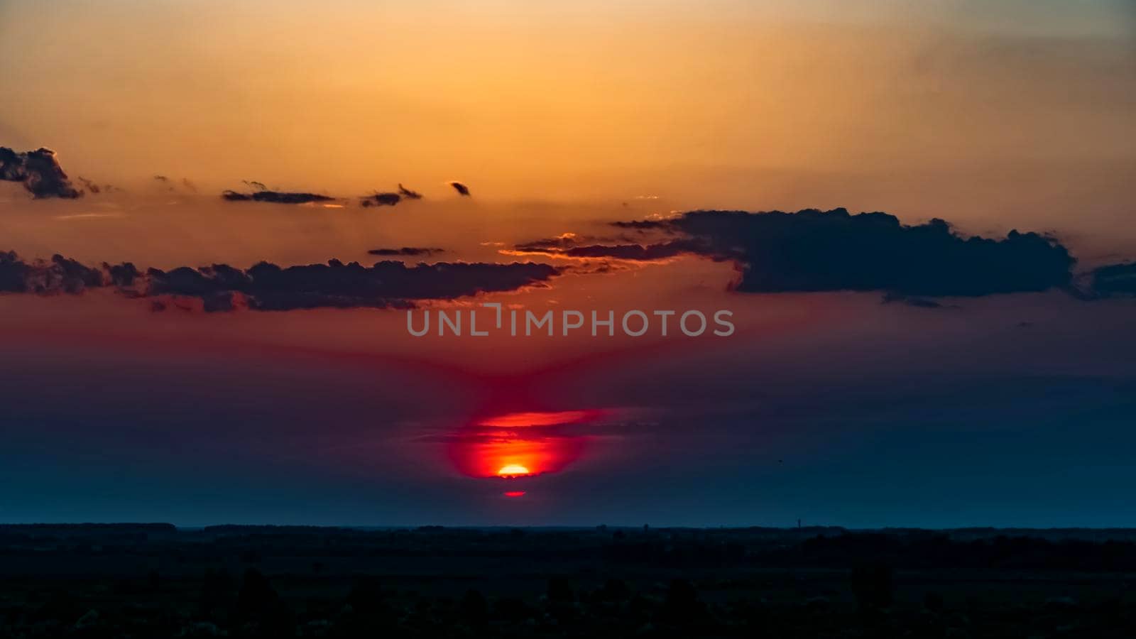 Sunset at the evening dawn.Morning dawn.Late evening.Evening sunset.The last rays of the sun in the evening hours and the onset of night.The first rays of the sun pass through the clouds.Glow pink sky