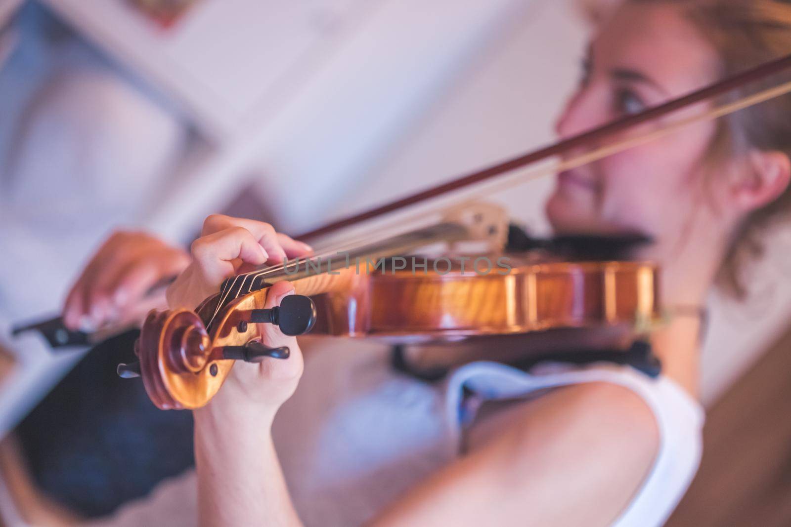 Pretty young girl practices on her violin, acoustic music