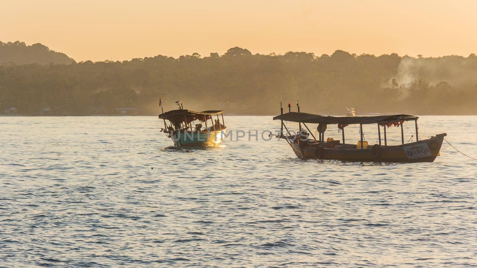 A sunset on Koh Rong island with boats