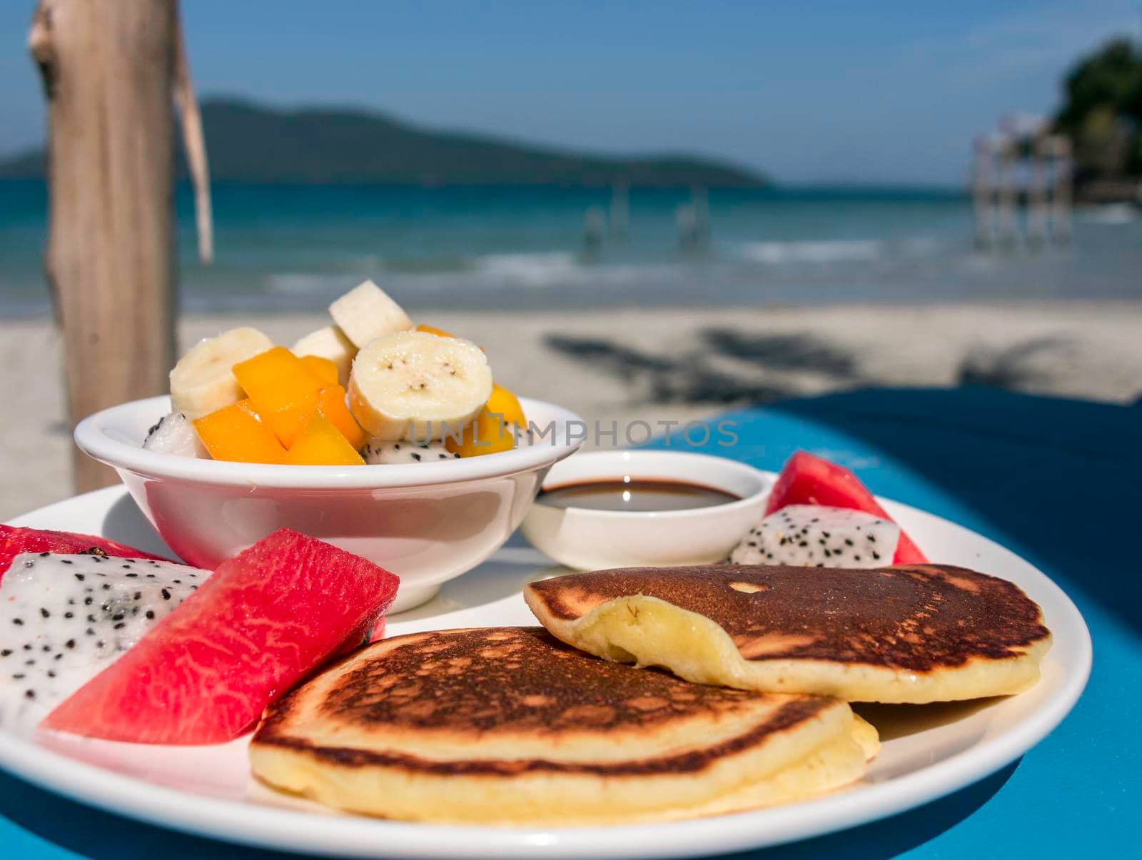 A fruit salad with panckes breakfast