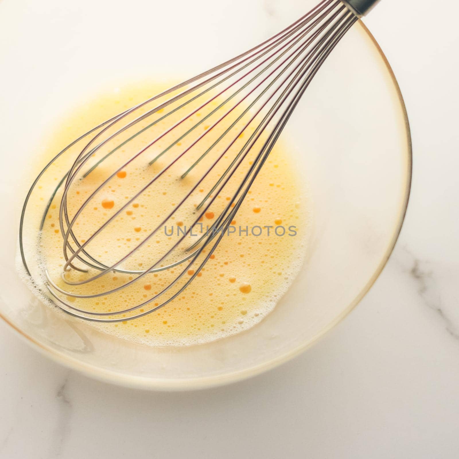 Cooking, meal and diet concept - Making of mixing eggs in bowl on marble table as homemade food flat lay, top view food brand photography flatlay and recipe for cooking blog, menu or cookbook design