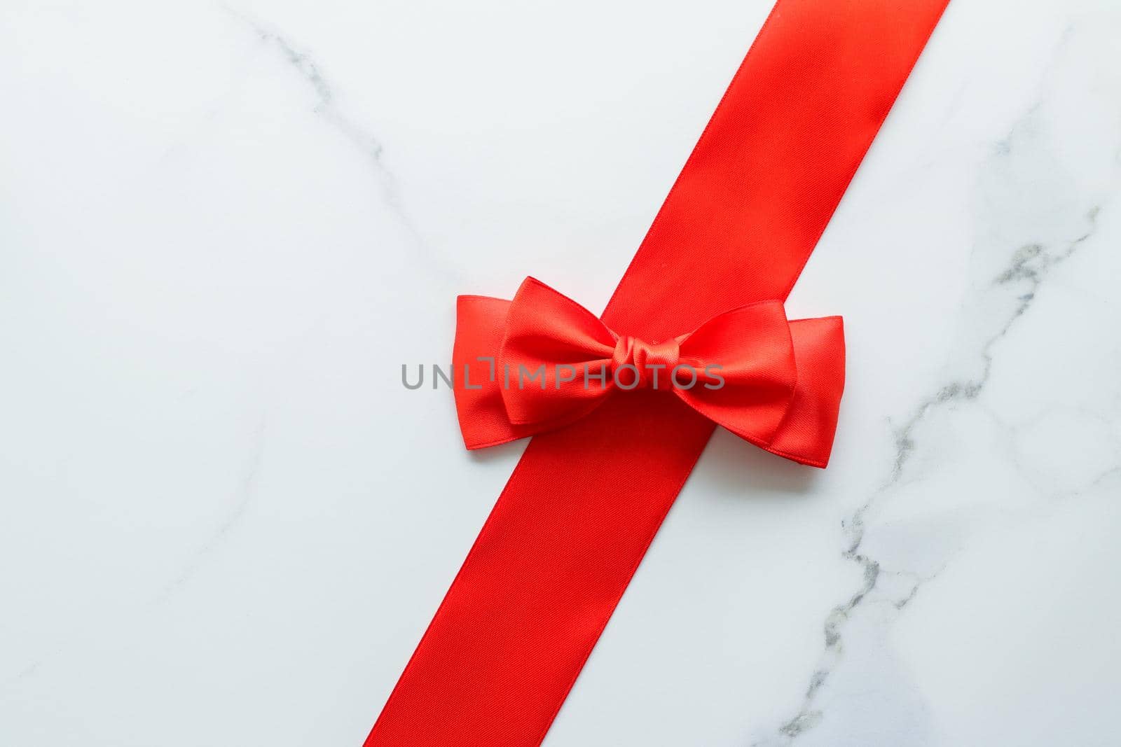 Holiday decor, feminine design and flatlay concept - Red silk ribbon on marble, top view