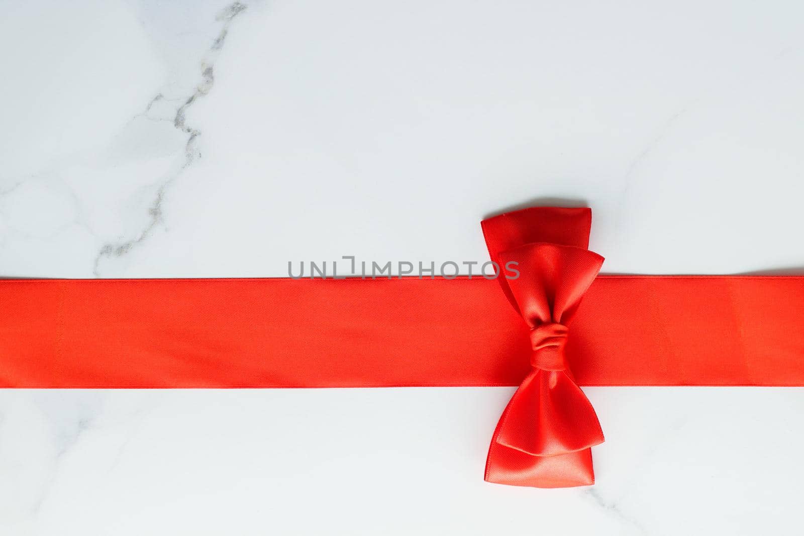 Holiday decor, feminine design and flatlay concept - Red silk ribbon on marble, top view