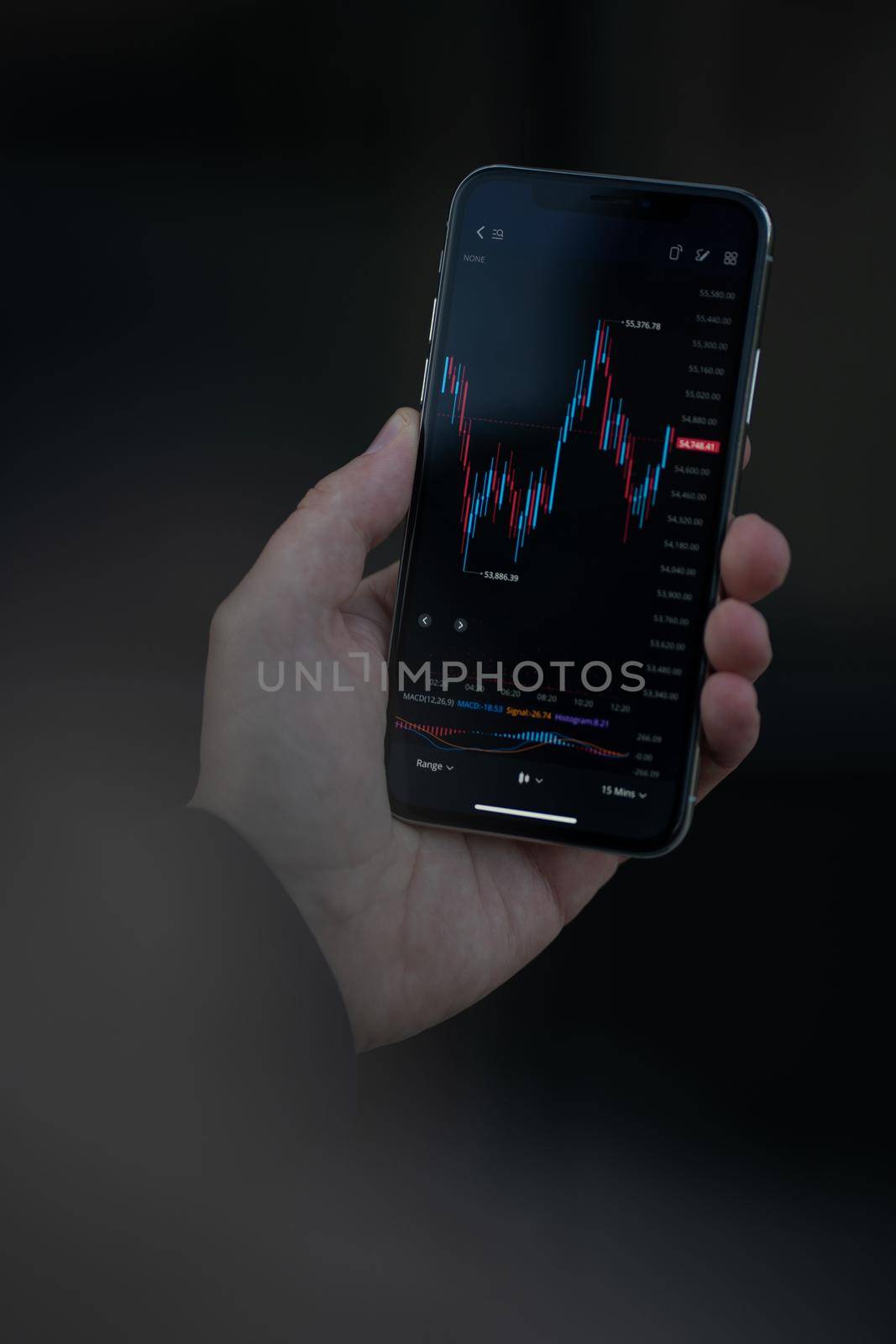 Online trading. Cropped shot of trader or investor reading financial news in real time, checking stock market data in modern mobile app on smartphone. Selective focus on screen with forex graph chart