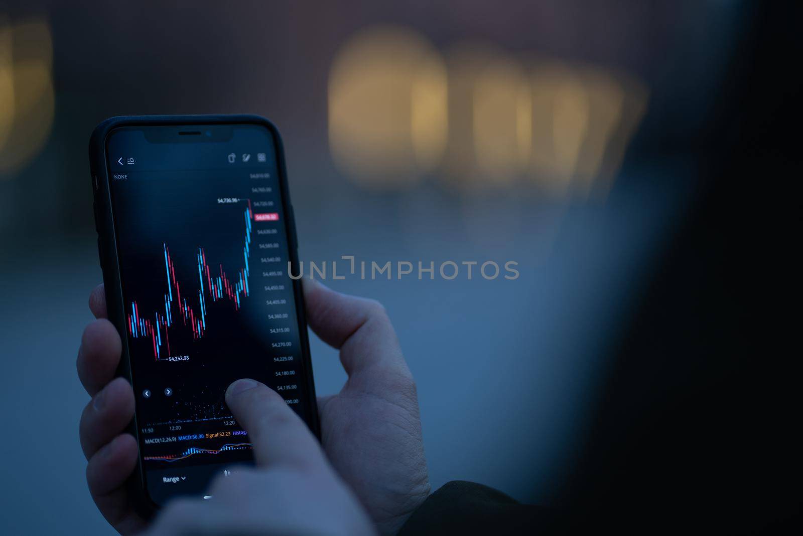 Trader checking stock market data on smartphone by vkstock