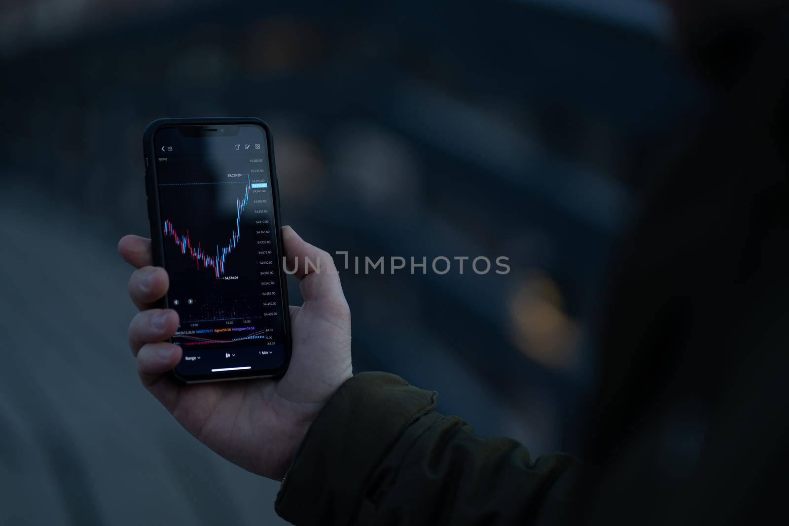 Businessman or trader analyzing forex chart and financial data on mobile phone screen by vkstock