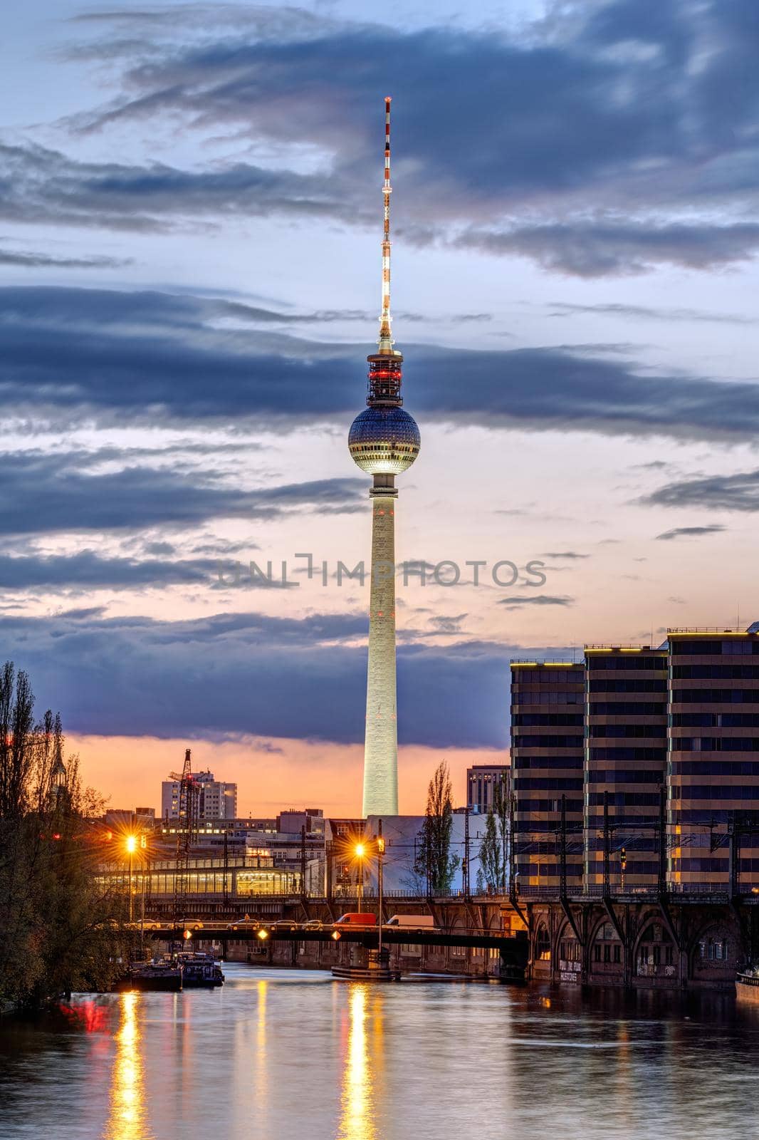The skyline of Berlin with the famous TV Tower and the river Spree after sunset