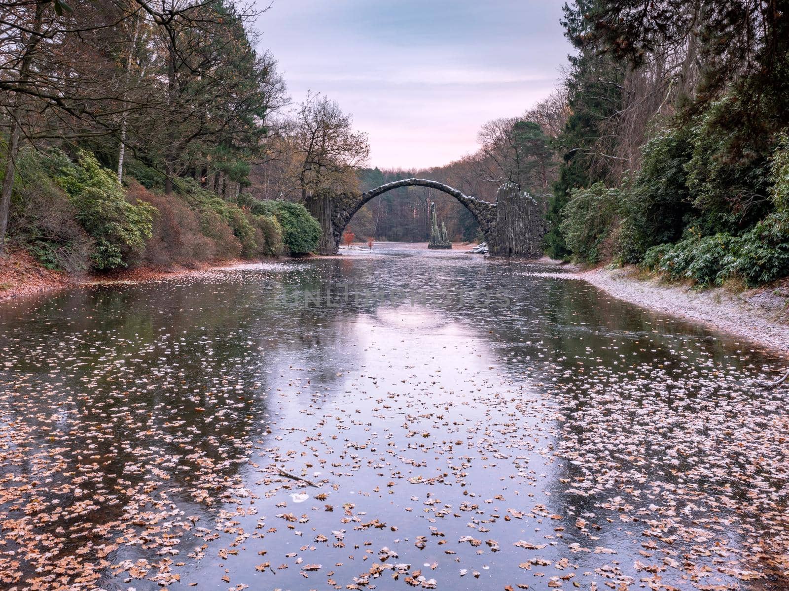 Chill autumn morning in park Kromlau. Round Arch basalt bridge  by rdonar2