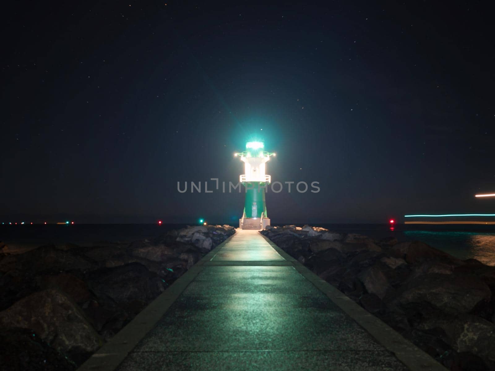 Bright light of Green and white breakwater lights at harbor entrance in Rostock Warnemunde, Germany 