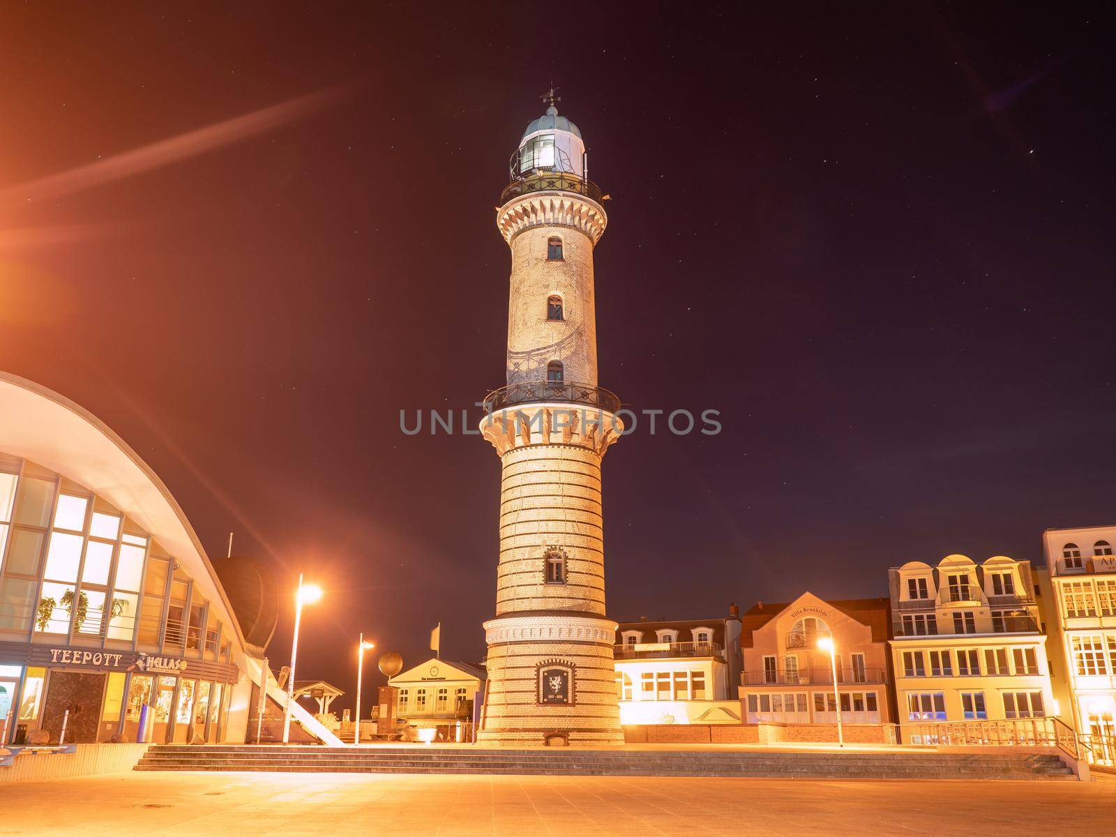 Old lighthouse and stony square  above emerald waters of harbor by rdonar2