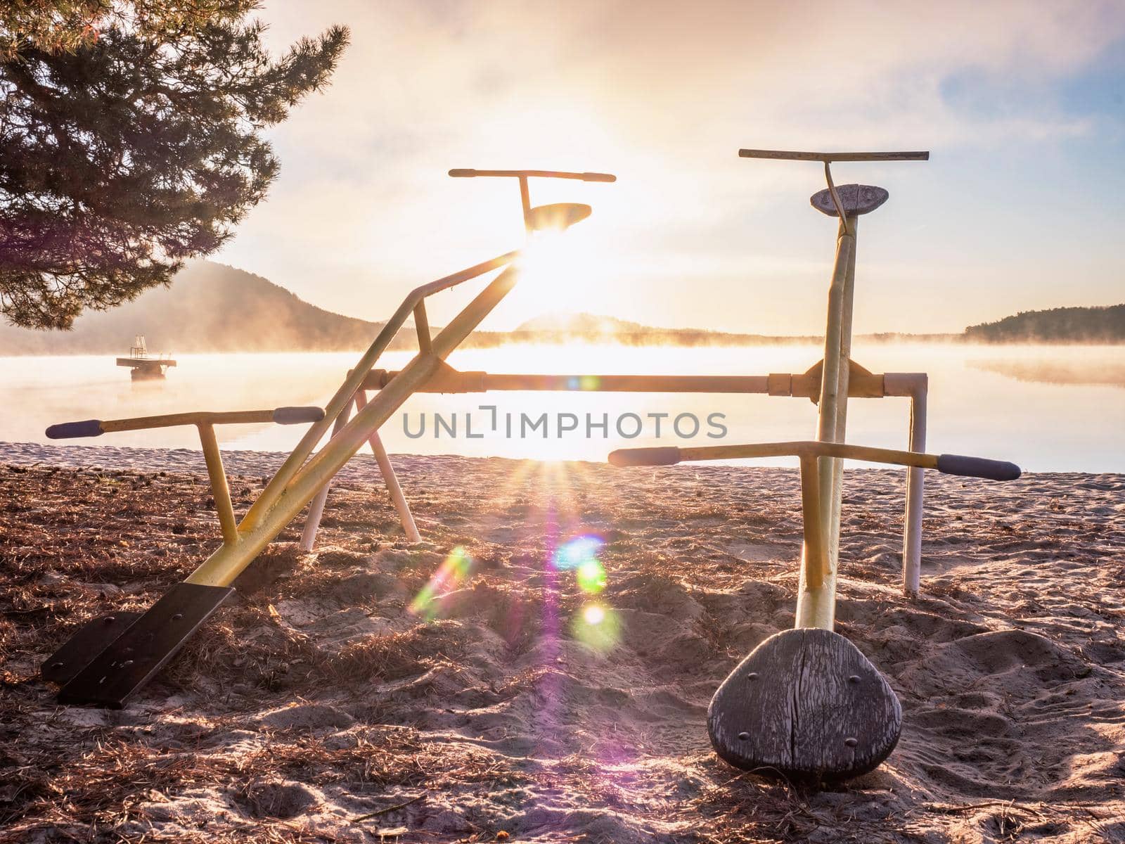 Swing or teeterboard on playground outdoors. Childhood, equipment and object concept