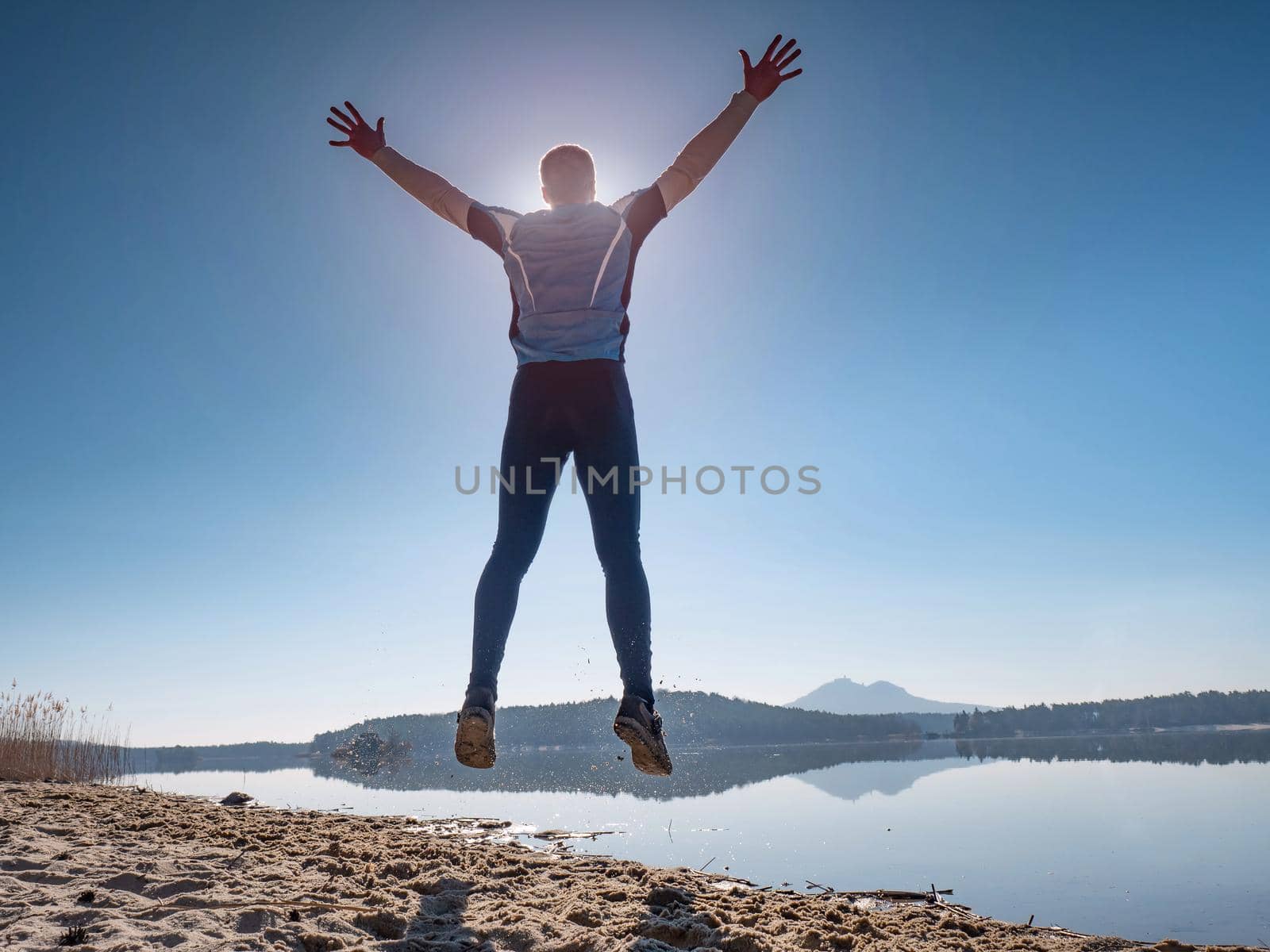 Man jumping on the beach at sunset. Funny happy man by rdonar2