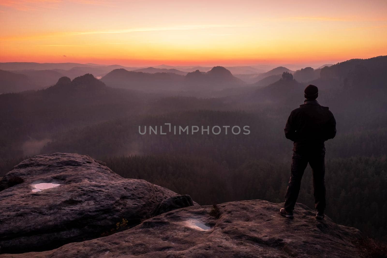 Alone tourist in black waiting for morning sun in mountains. by rdonar2