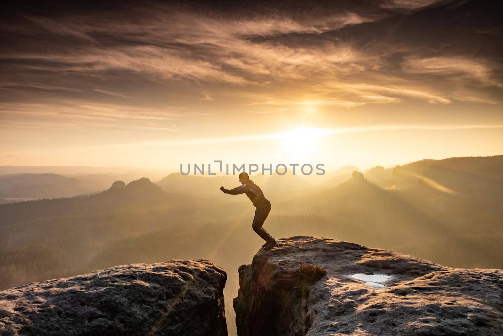 Man jumping over pekas against sky during sunset. Pure excitment in the mountains 