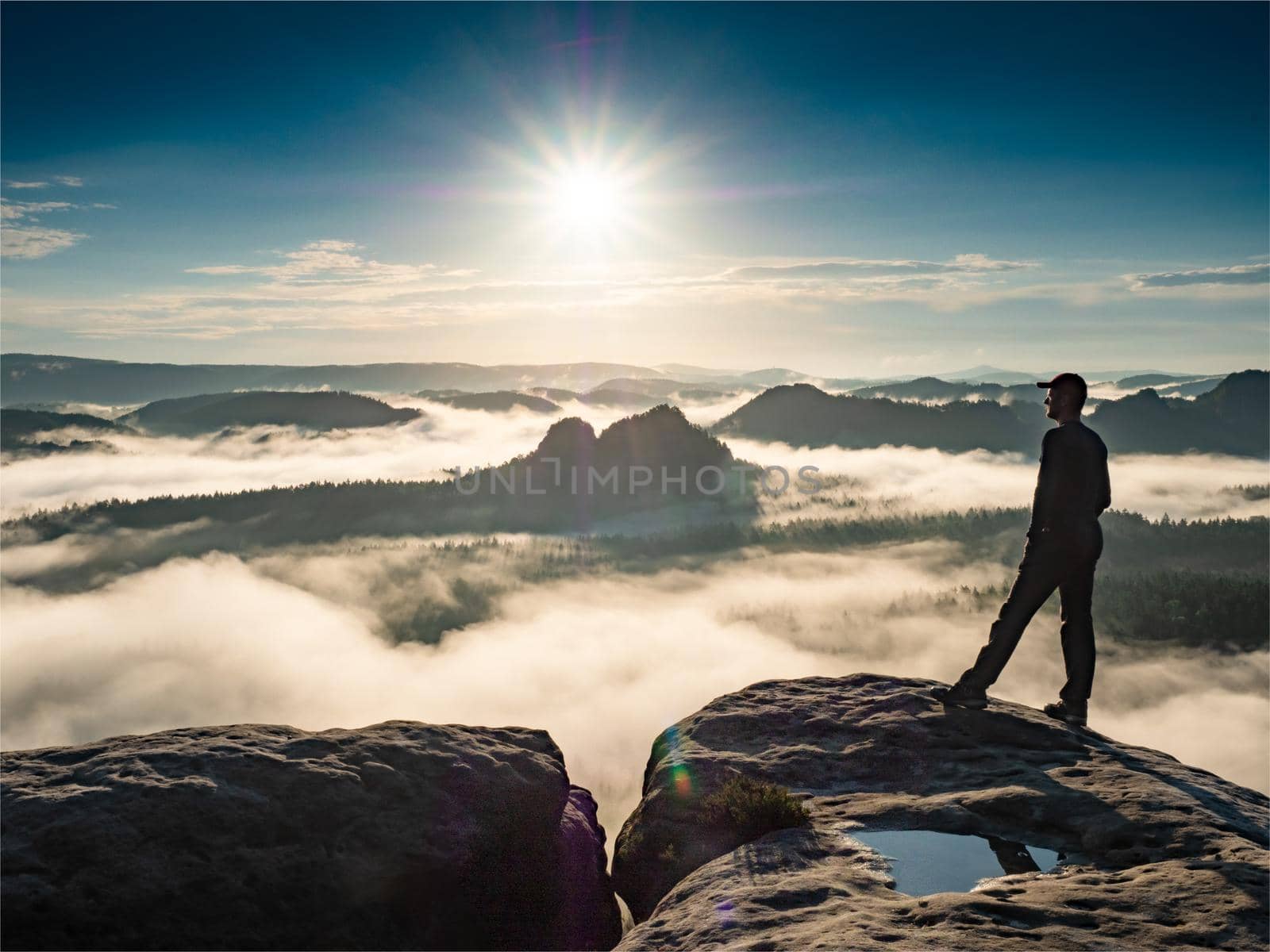 Kleiner Winterberg daybreak view. Unique sandstone cliffs and deep misty valley in Saxony Switzerland, Germany. Fog and beautiful backlight. Attractive travel landscape Europe.