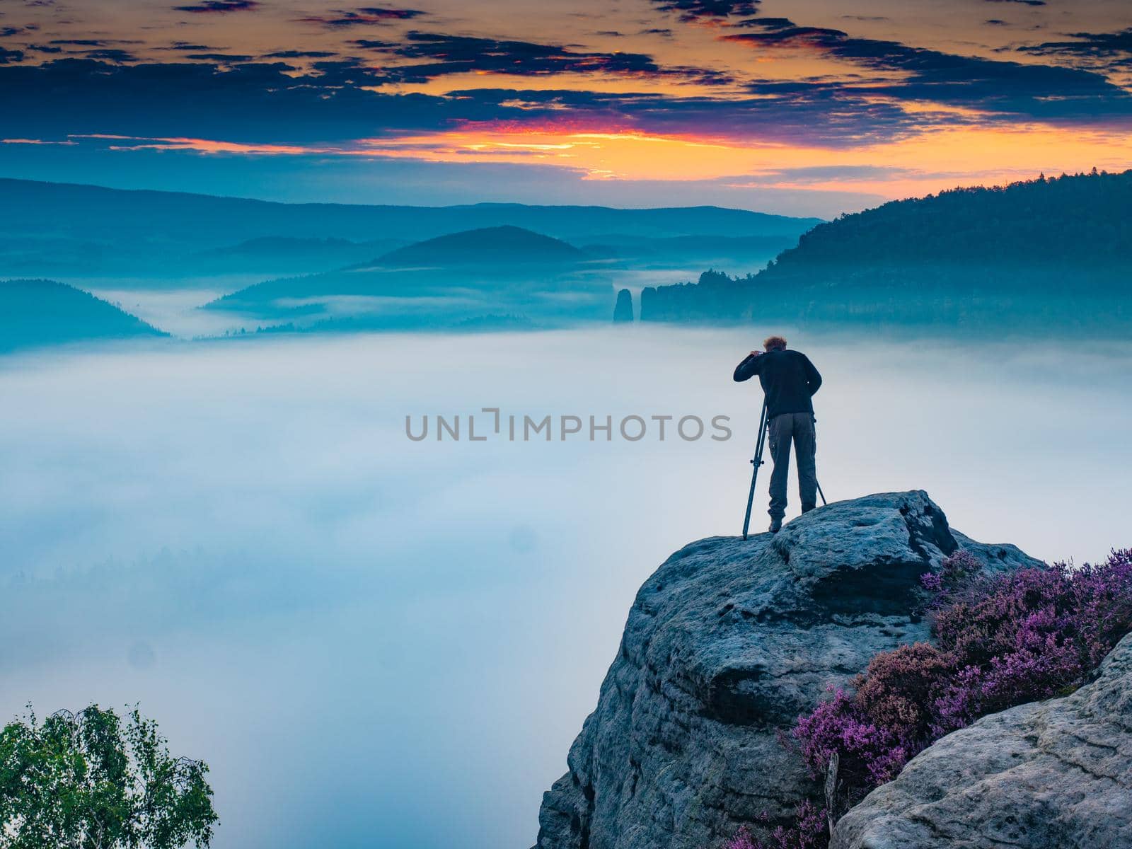 Silhouette man photographing against misty landscape and morning sky by rdonar2