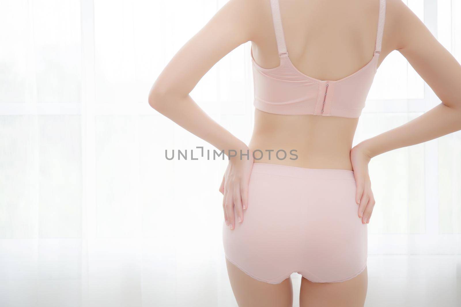 Closeup bottom of asian sexy woman in underwear beautiful body slim shape slender with diet at room, girl is weight loss with perfect body of buttock at home, healthy and lifestyle concept.
