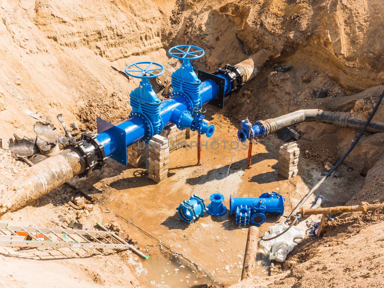 Construction site of a new hydraulic system of drinking water to be carried out under the road surface level.