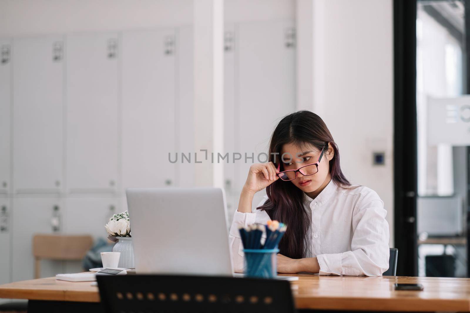 Photo of beautiful asian business lady resourceful person with glasses looking seriously laptop computer watching online training at home office
