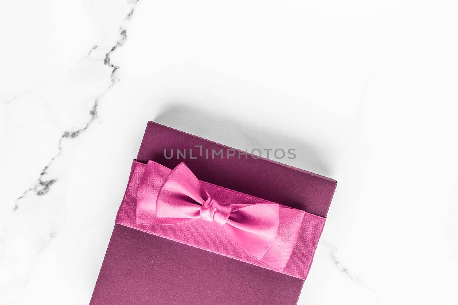 Birthday, wedding and girly branding concept - Pink gift box with silk bow on marble background, girl baby shower present and glamour fashion gift for luxury beauty brand, holiday flatlay art design