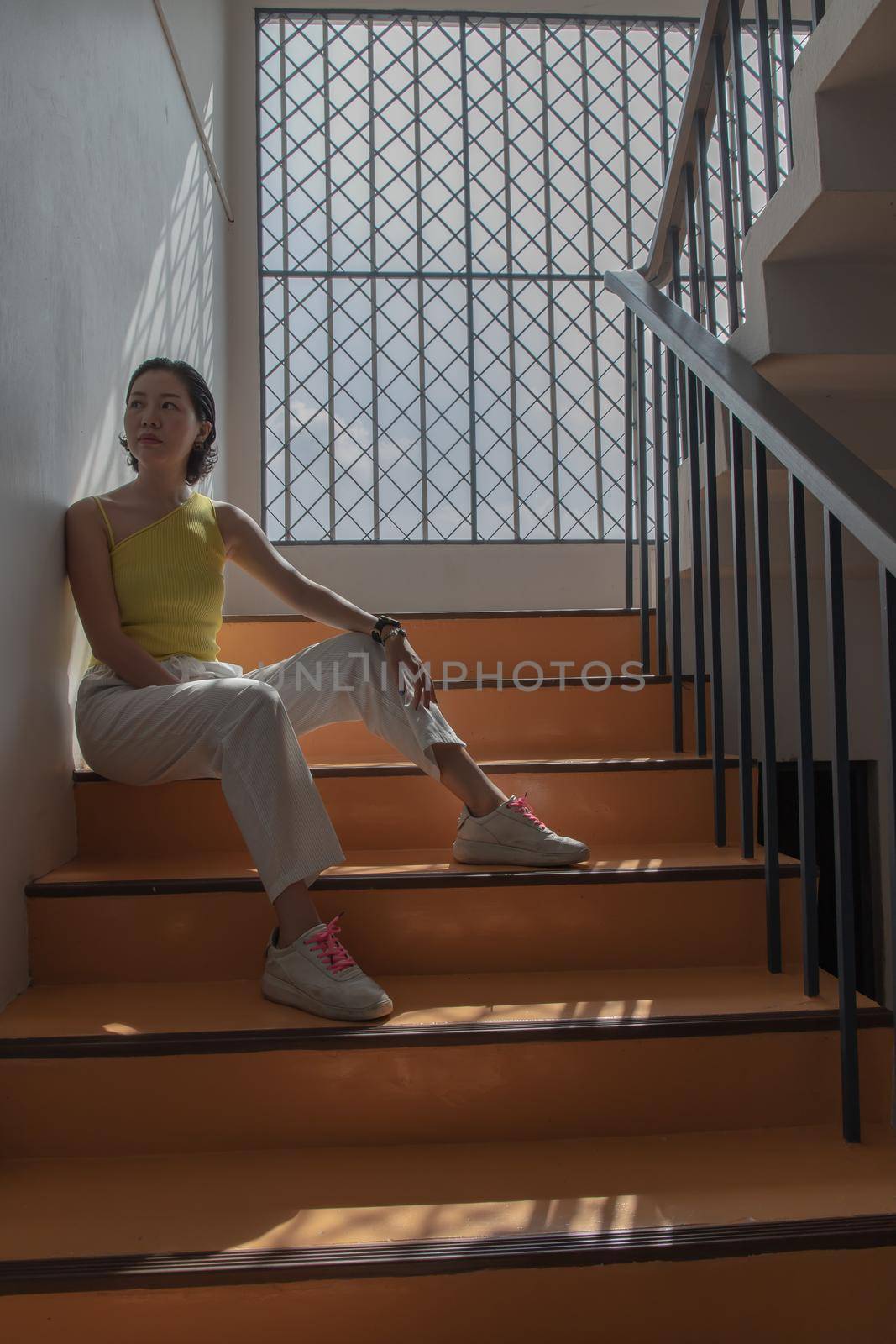 Young asian woman and short hair posing for take a photo on stairs. Selective focus.