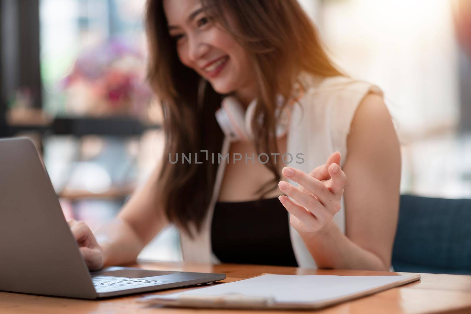 Close up hand of attractive asian business woman working with laptop computer for group online meeting conference, by nateemee