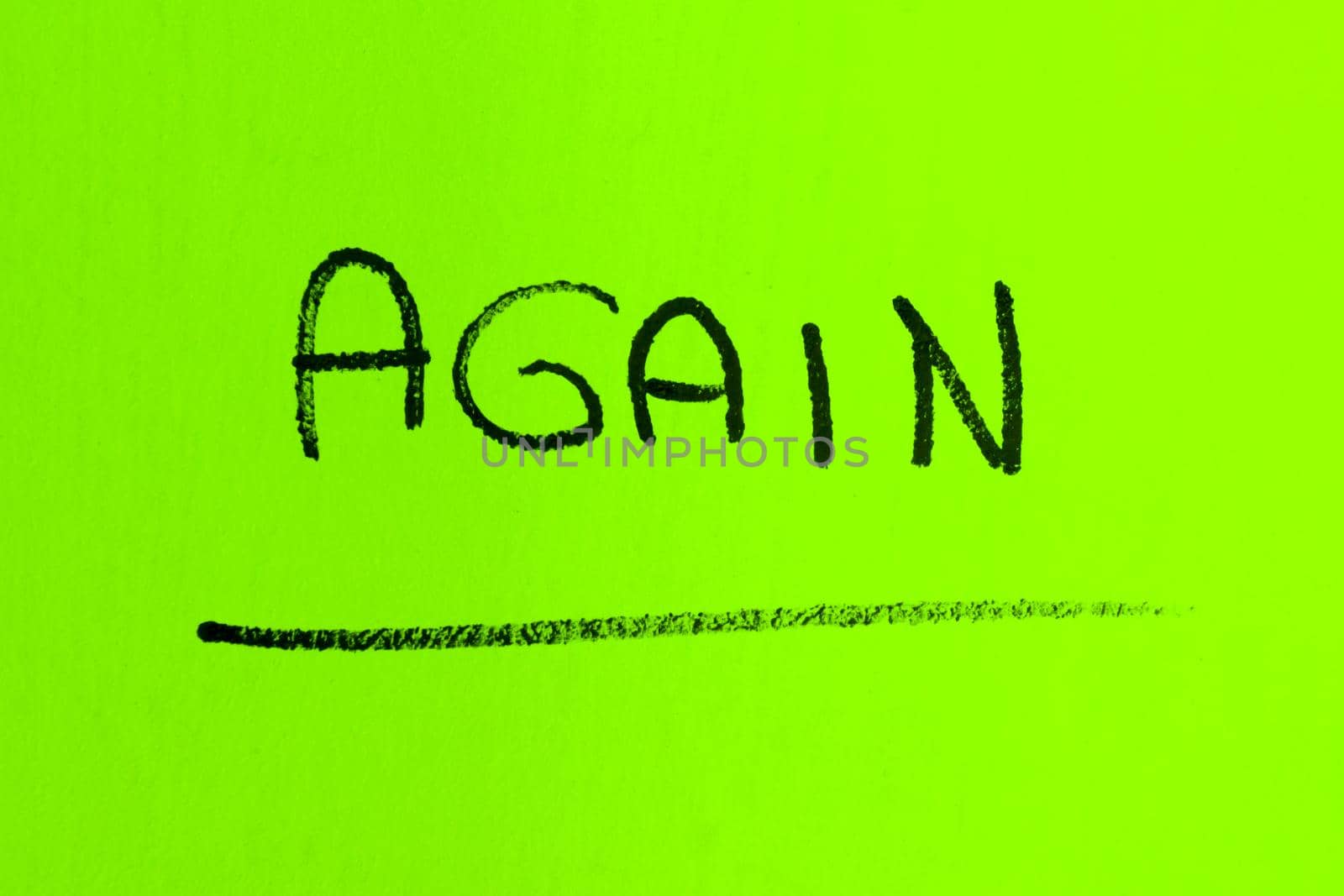 AGAIN word made with spray paint on green background