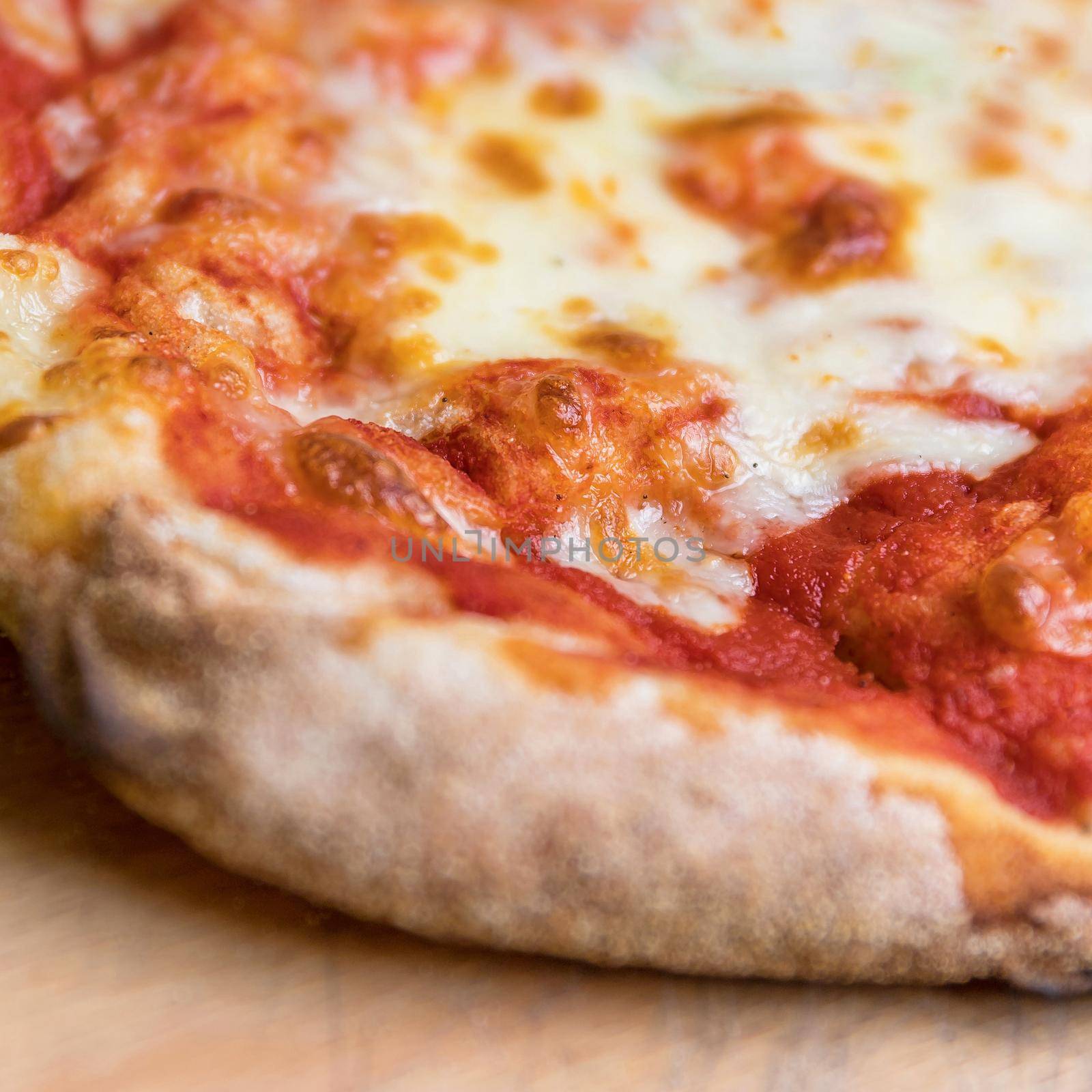 Pizza Margherita. Closeup shot of an italian pizza margherita with tomato souce and mozzarella di bufala cheese. Shallow DOF.