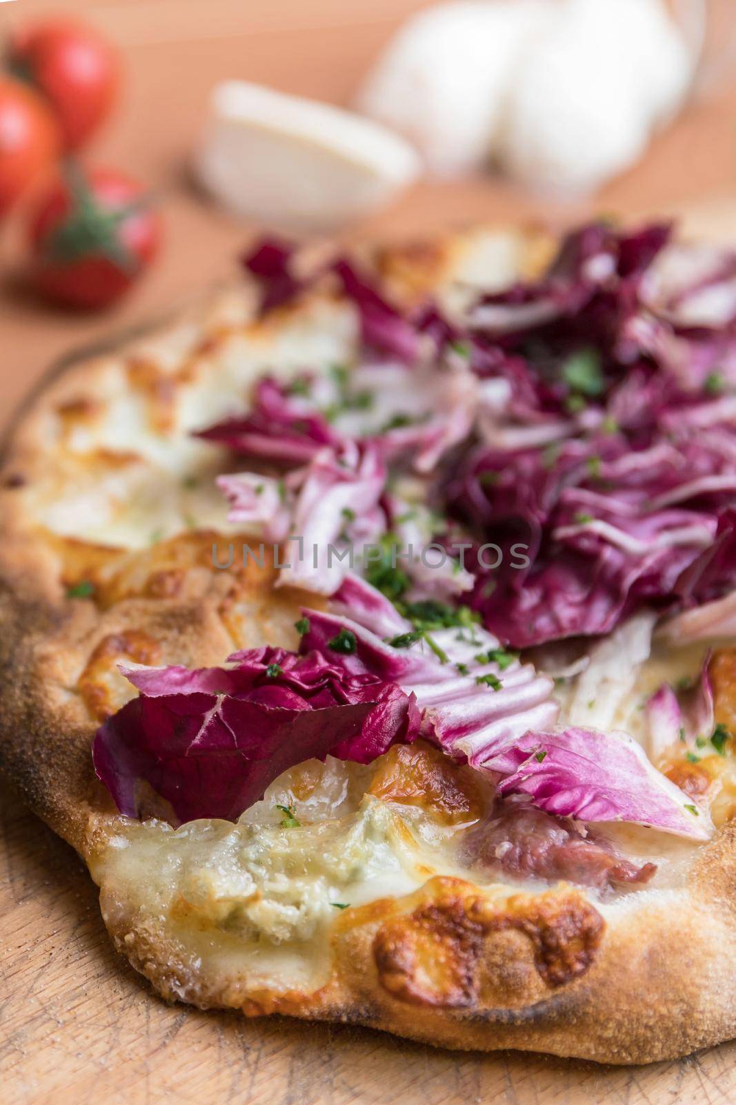 Italian pizza with mozzarella and radicchio salad. Shallow DOF.