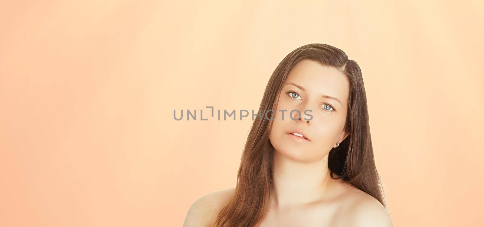 Sunny face portrait of young woman, suntan skin tone and beauty cosmetics. Beautiful brunette female model with natural tan using sunscreen product.