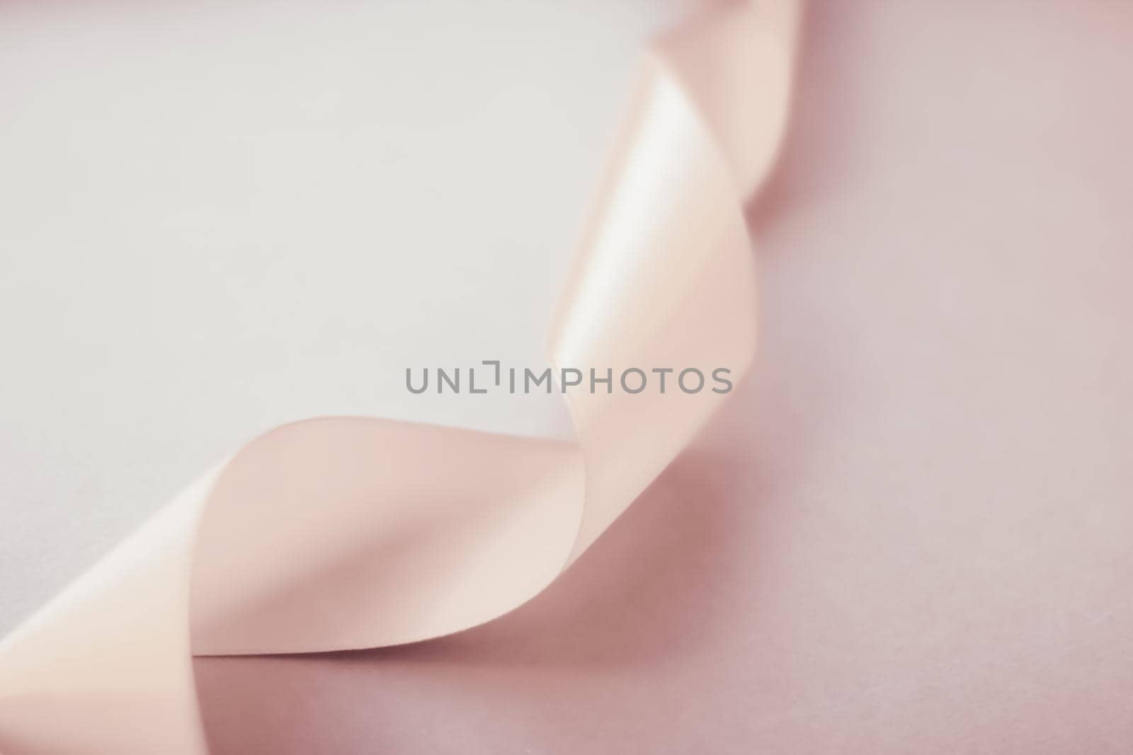 Branding, holidays and luxe brands concept - Abstract curly silk ribbon on pastel background, exclusive luxury brand design for holiday sale product promotion and glamour art invitation card backdrop