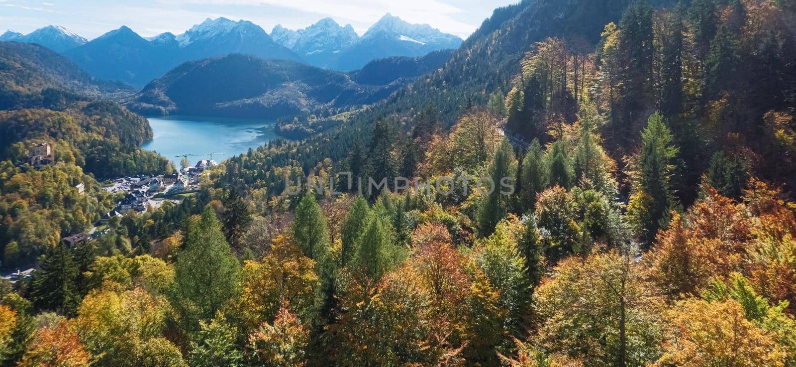 Beautiful nature of European Alps, landscape view of alpine mountains, lake and village on a sunny day, travel and destination scenery
