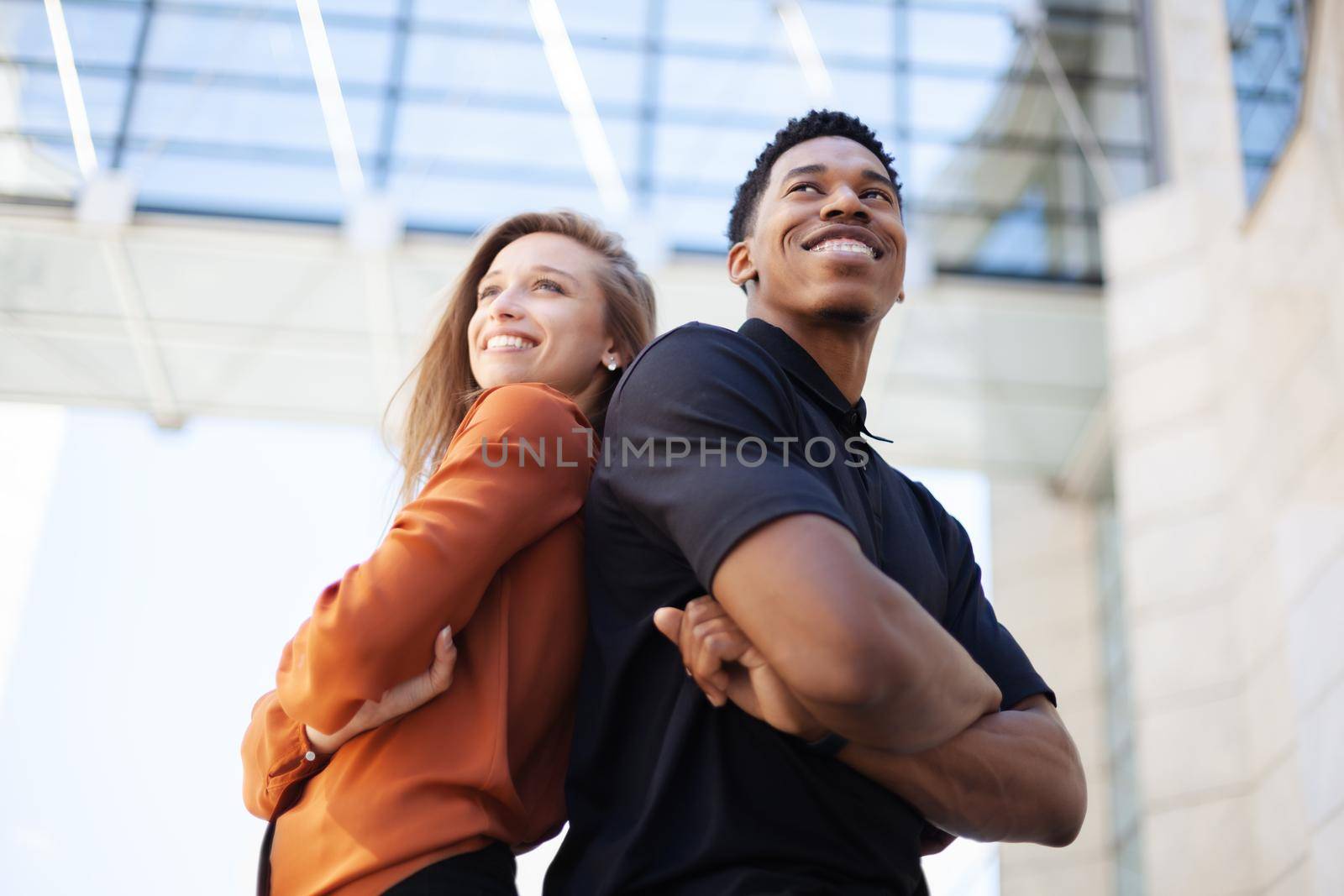 successful business couple standing in front of office center. by kokimk