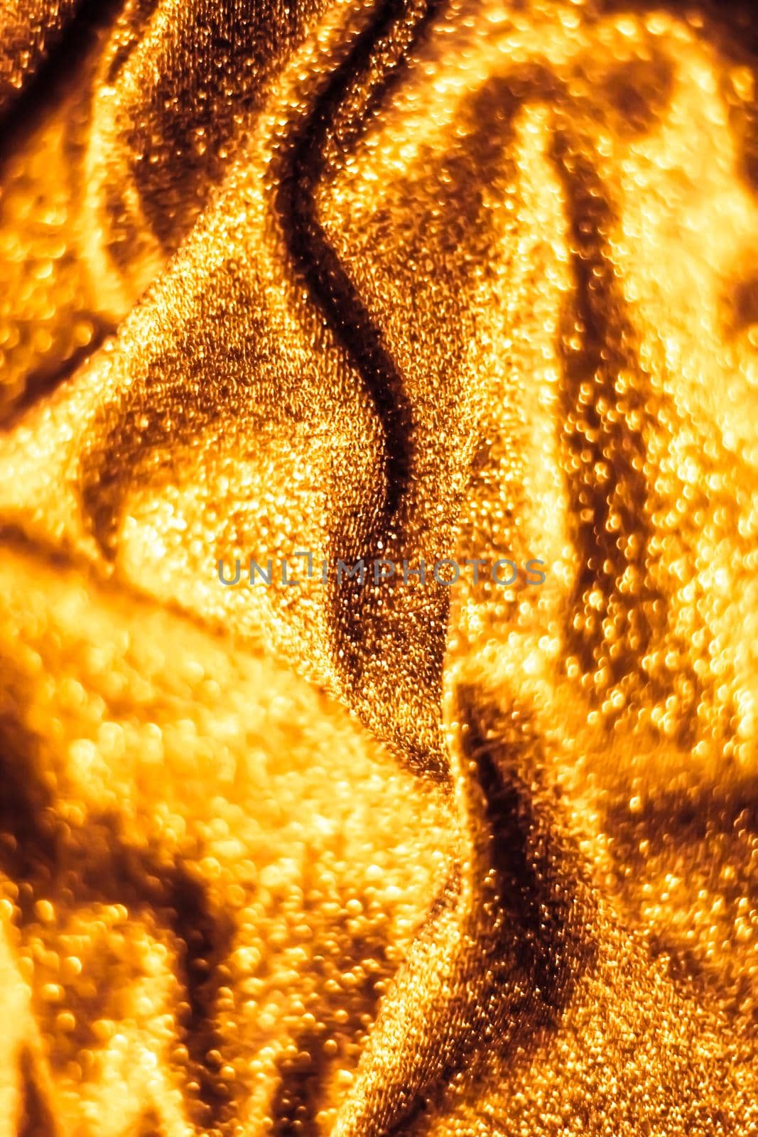 Luxe glowing texture, night club branding and New Years party concept - Golden holiday sparkling glitter abstract background, luxury shiny fabric material for glamour design and festive invitation