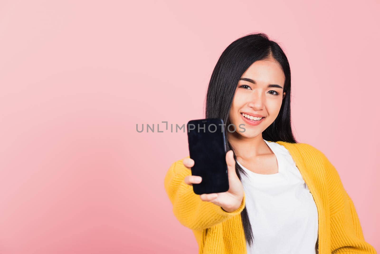 woman teen smiling excited  holding blank screen mobile phone by Sorapop