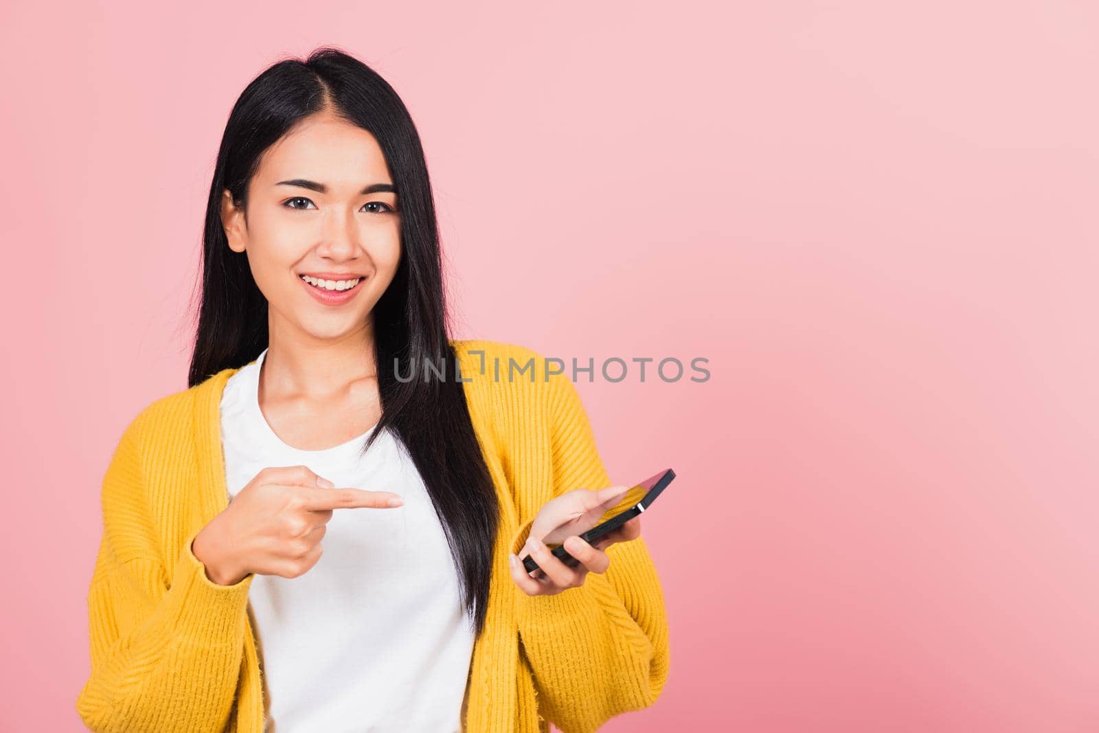 beautiful young woman smile making finger pointing on smartphone in hand shopping by Sorapop