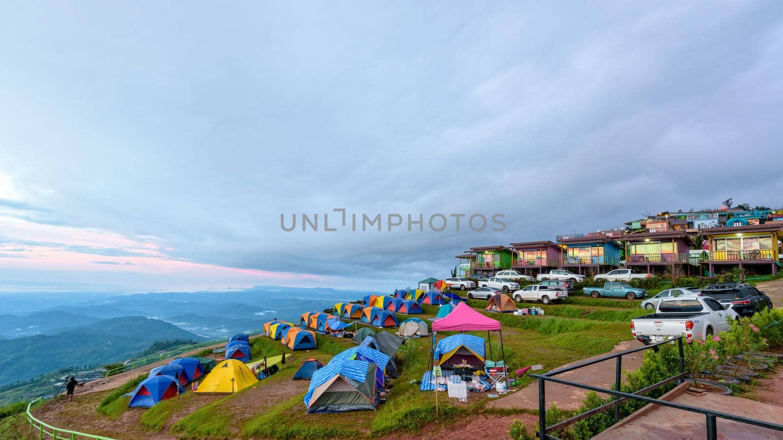 PHETCHABUN, THAILAND-OCT 24,2018: Tourists, cars, tents and resorts on camping areas and beautiful nature of the mountain and forest during sunrise at Phu Thap Berk viewpoint