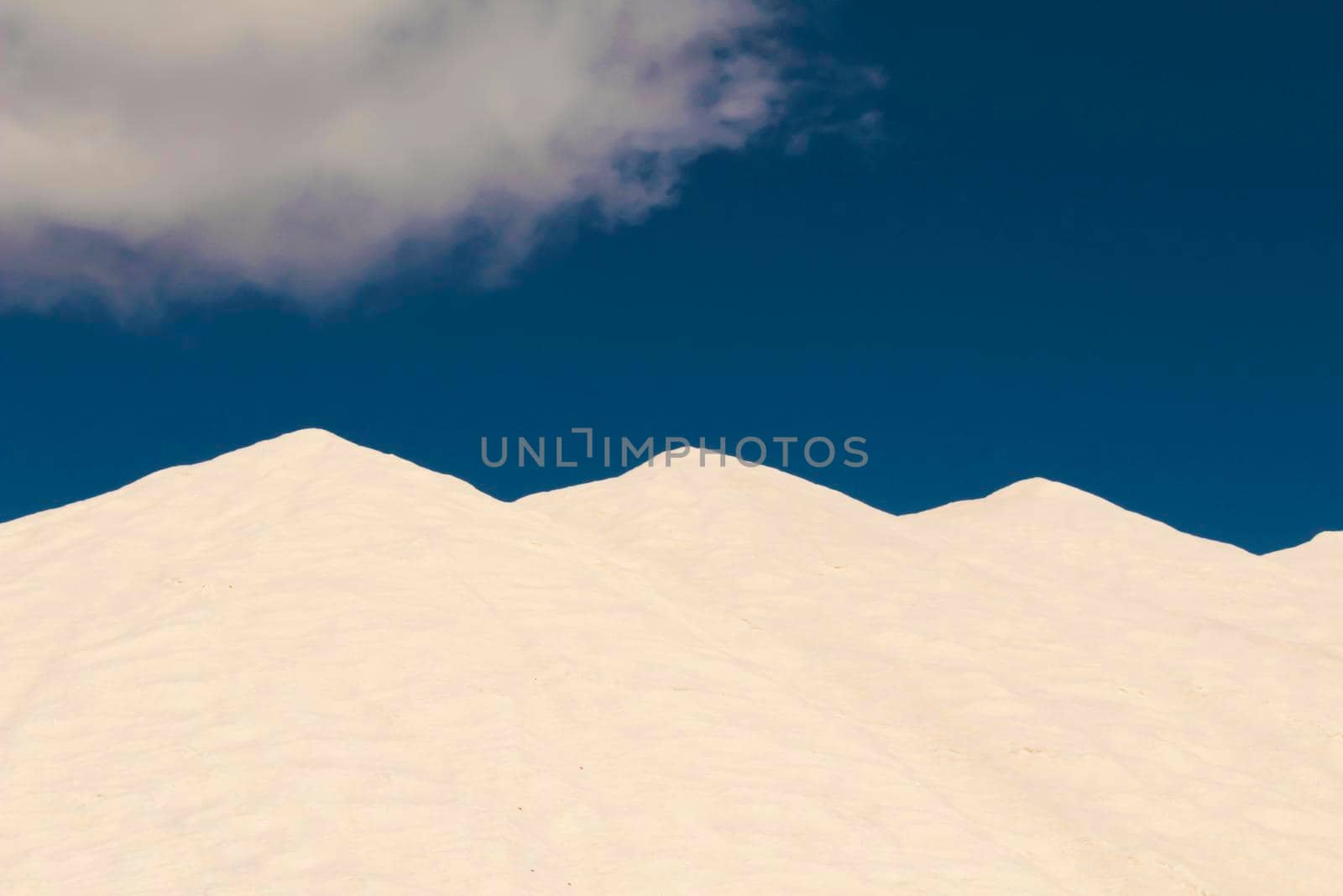 Salt mountains under blue sky in Santa Pola, Spain