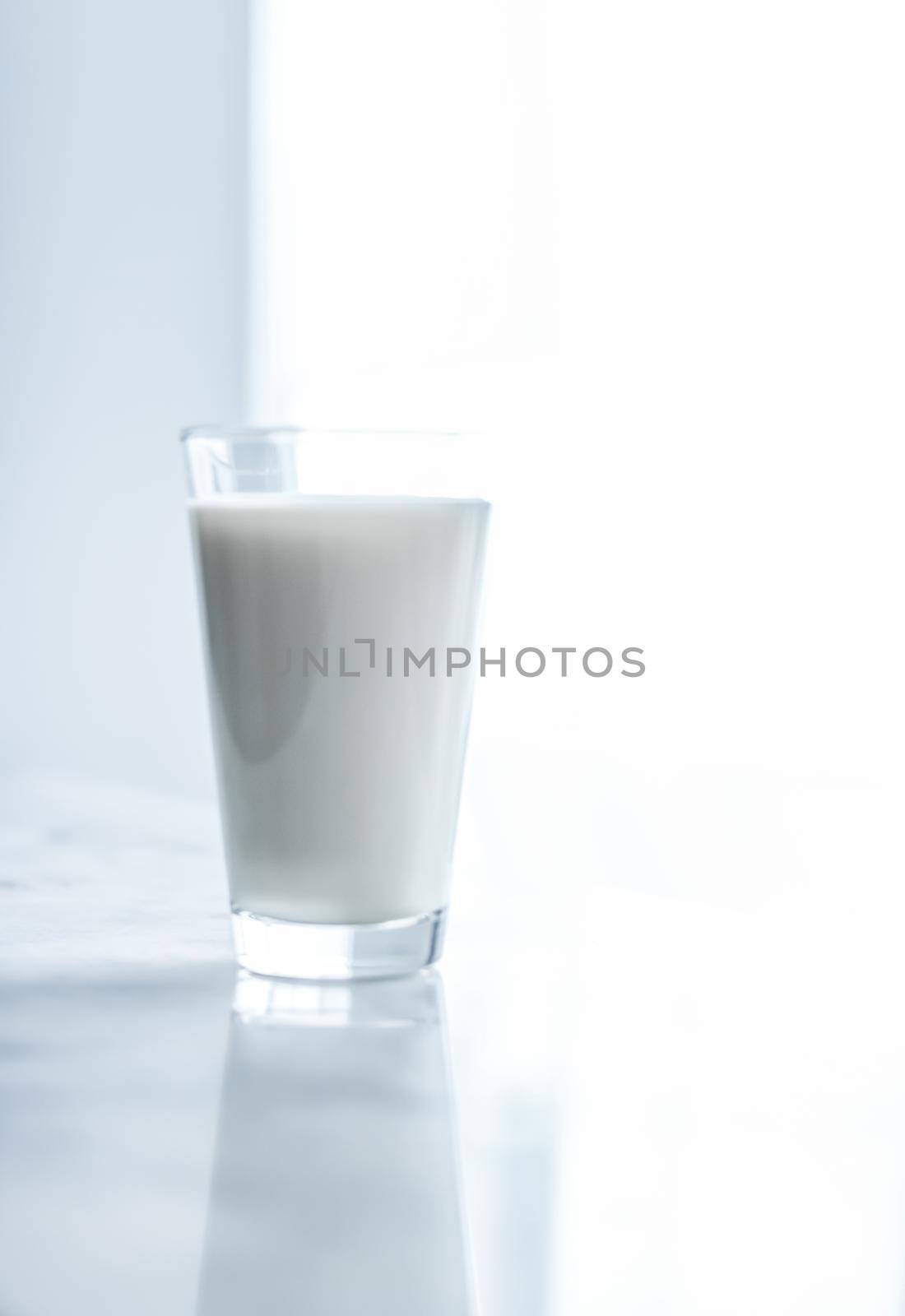 Dairy, healthy nutrition and breakfast concept - World Milk Day, full glass on marble table
