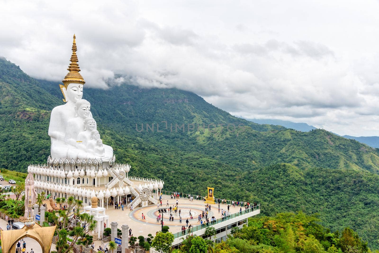 PHETCHABUN, THAILAND-OCT 24,2018: Many tourists on the terrace viewpoint under the large white Buddha statue on mountain at Wat Phra That Pha Sorn Kaew Temple in Khao Kho, Phetchabun, Thailand