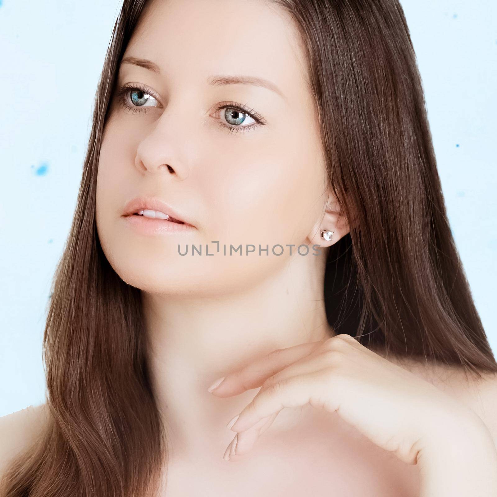 Rejuvenation skincare and beauty ad, beauty face portrait of young woman with healthy clean skin, blue cosmetic liquid drops on background.